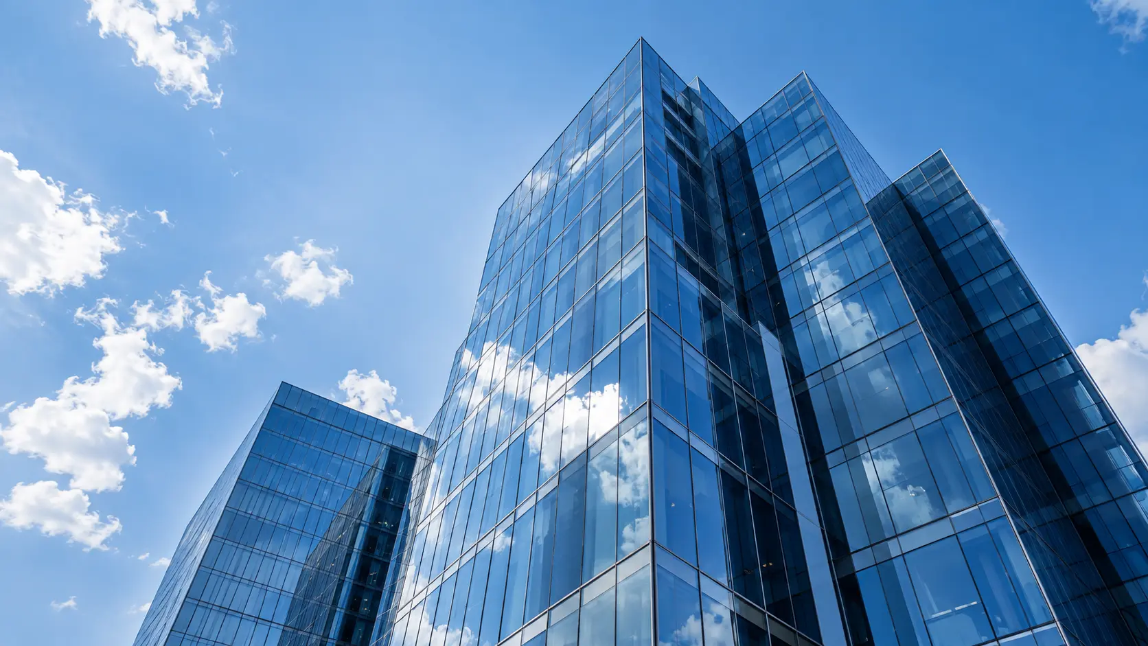 Modern blue glass architecture against a clear sky