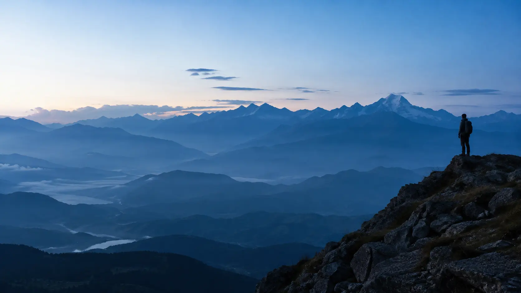 A hiker looking across a mountain horizon